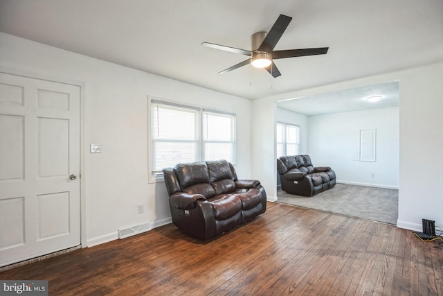 living room with dark wood-type flooring and ceiling fan