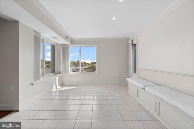 interior space with ornamental molding and light tile patterned flooring