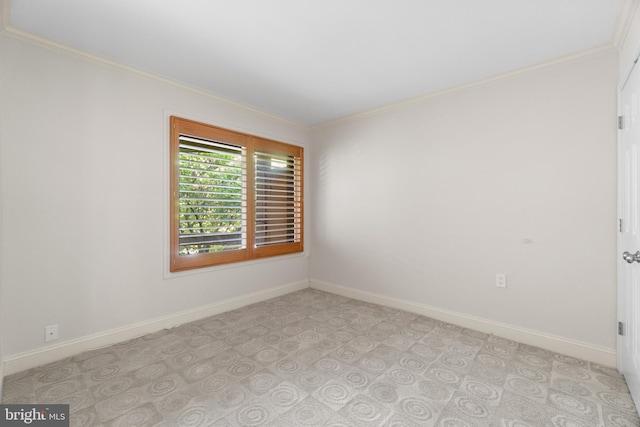 spare room featuring crown molding