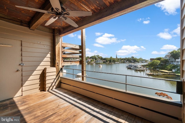 balcony featuring a water view and ceiling fan