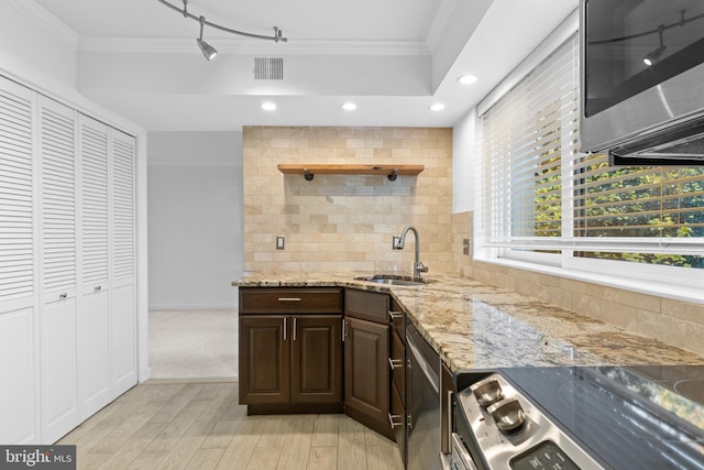 kitchen featuring sink, crown molding, appliances with stainless steel finishes, and tasteful backsplash