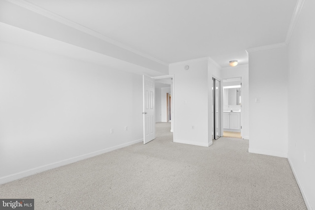 empty room with light colored carpet and ornamental molding