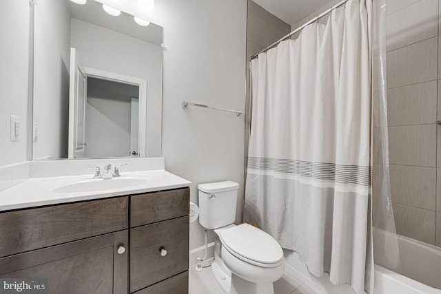 bathroom with toilet, shower / bath combo, and vanity