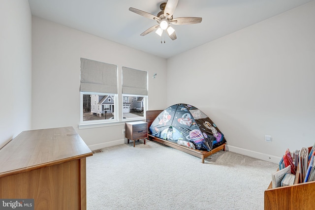 carpeted bedroom with a ceiling fan, visible vents, and baseboards