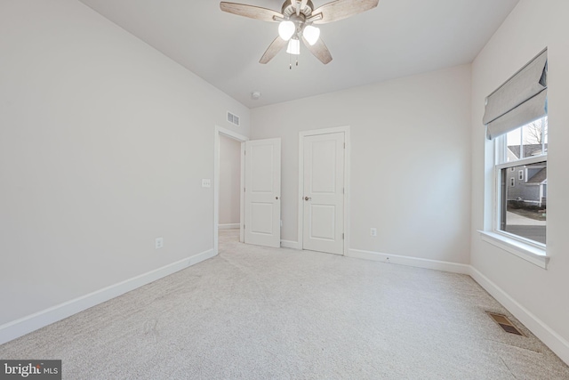 unfurnished bedroom with carpet, visible vents, and baseboards