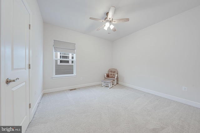 interior space with baseboards, visible vents, a ceiling fan, and carpet flooring