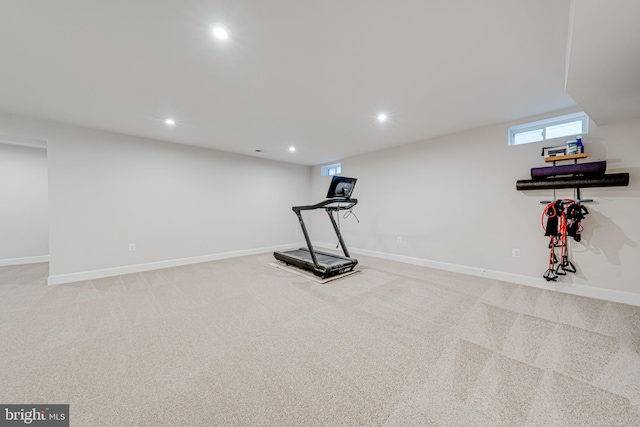 exercise room with recessed lighting, light colored carpet, and baseboards