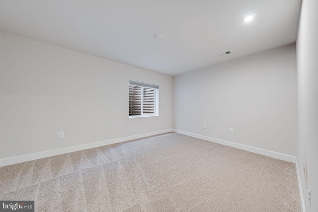 carpeted spare room with recessed lighting, visible vents, and baseboards