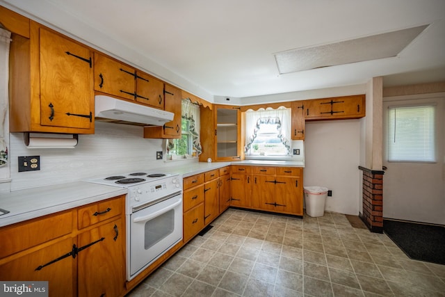 kitchen with decorative backsplash and white range with electric cooktop