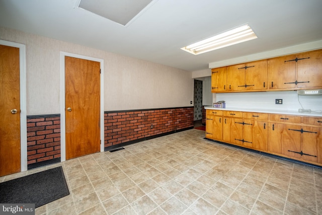 kitchen featuring brick wall