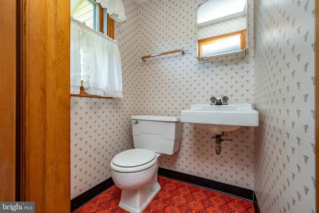 bathroom with toilet and tile patterned floors