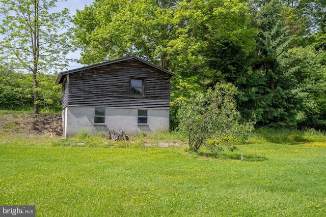 view of property exterior with a lawn