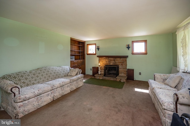 living room with a fireplace and carpet