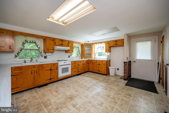 kitchen featuring sink, a healthy amount of sunlight, and oven