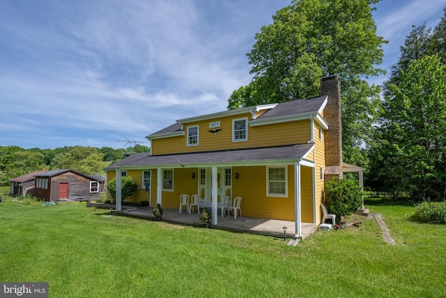 back of property featuring a lawn