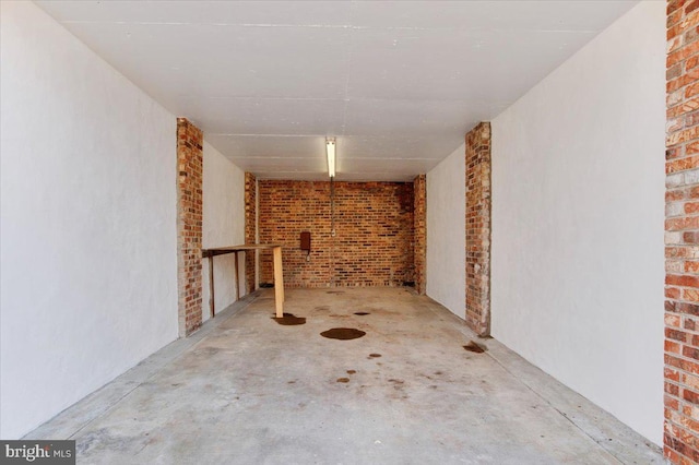 basement featuring brick wall