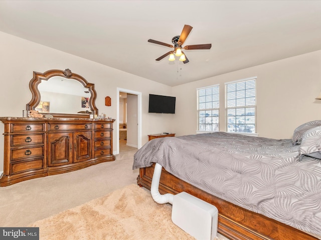 bedroom with ceiling fan and light carpet