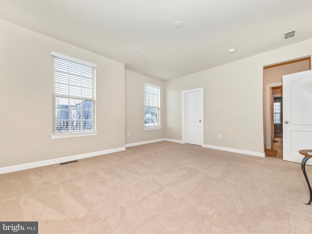 unfurnished room featuring light colored carpet