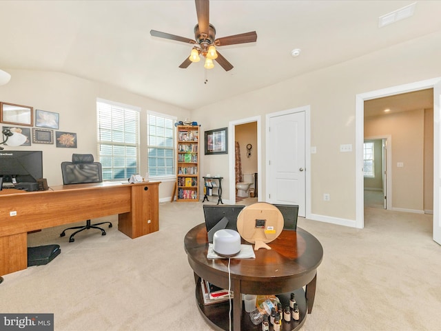 carpeted office with plenty of natural light, ceiling fan, and vaulted ceiling