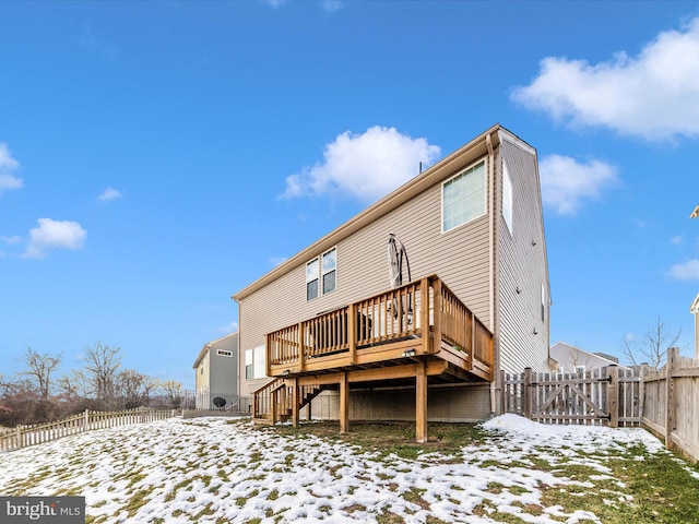 snow covered property with a wooden deck