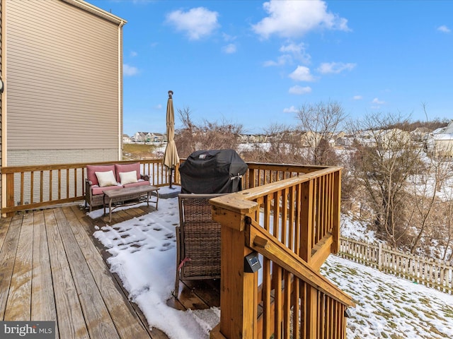 snow covered deck featuring grilling area