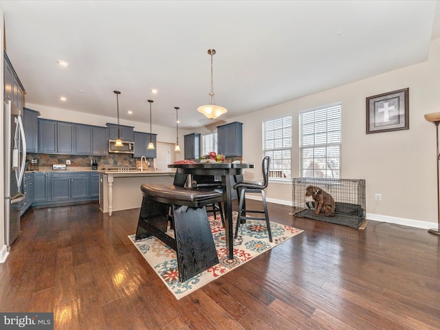 dining area with dark wood-type flooring and sink