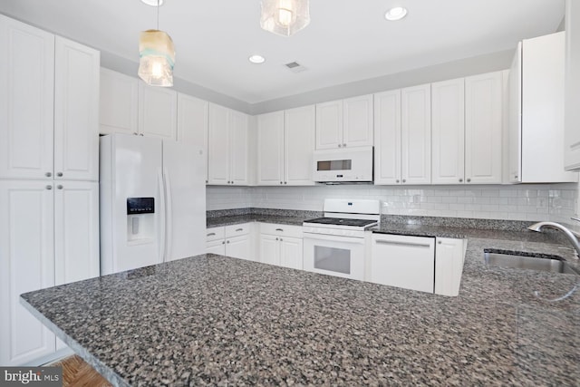 kitchen featuring pendant lighting, sink, white cabinets, decorative backsplash, and white appliances