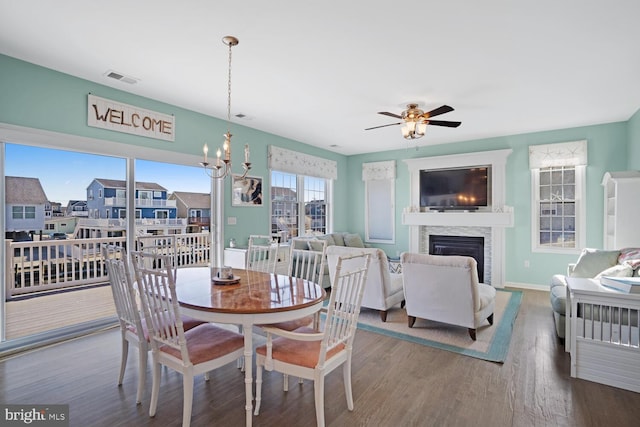 dining room featuring hardwood / wood-style floors and ceiling fan with notable chandelier