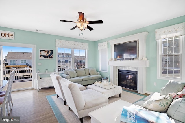 living room with light hardwood / wood-style flooring and ceiling fan