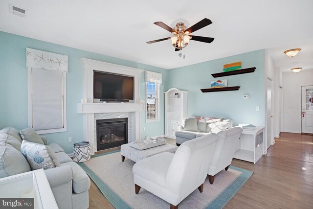 living room featuring ceiling fan and wood-type flooring