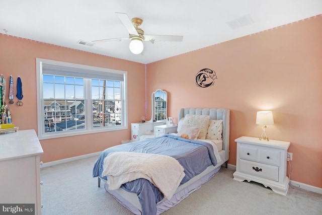 bedroom featuring light carpet and ceiling fan