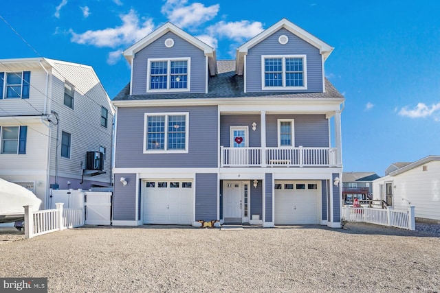 view of front facade with a garage and central AC