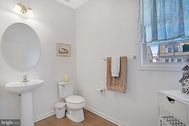 bathroom with hardwood / wood-style flooring, sink, and toilet