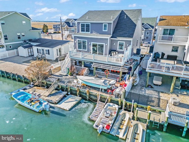 rear view of house featuring a water view