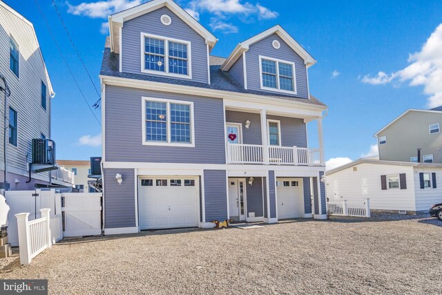 view of front of home featuring a garage and central AC