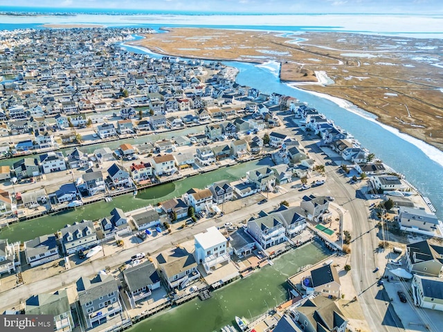 drone / aerial view with a water view and a view of the beach