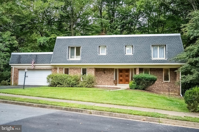 view of front of house with a garage and a front lawn