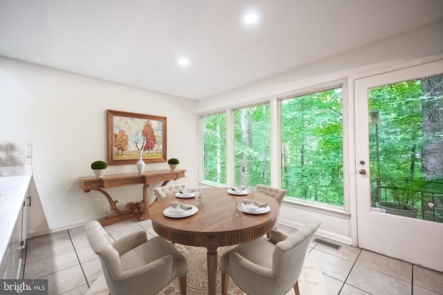 tiled dining room with a wealth of natural light