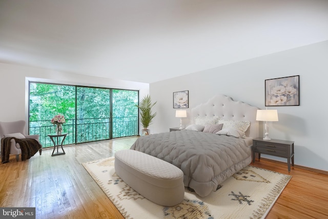 bedroom featuring hardwood / wood-style flooring and access to outside