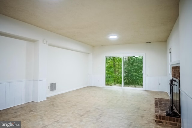 unfurnished living room featuring a fireplace