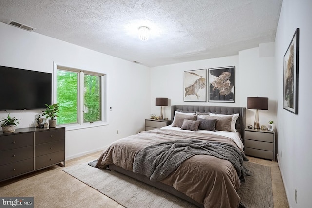 carpeted bedroom with a textured ceiling