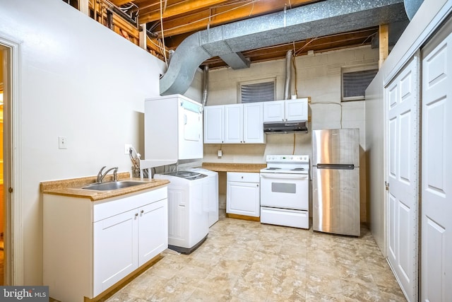 kitchen featuring white range with electric cooktop, sink, white cabinets, stacked washer and dryer, and stainless steel refrigerator