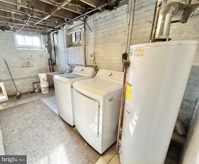 laundry room featuring water heater, sink, and washer and clothes dryer