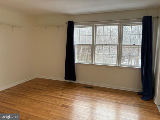 empty room with light hardwood / wood-style flooring