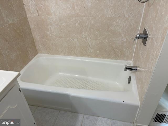 bathroom featuring tile patterned flooring, vanity, and a bathtub