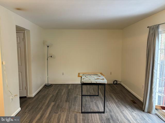 miscellaneous room featuring dark wood-type flooring