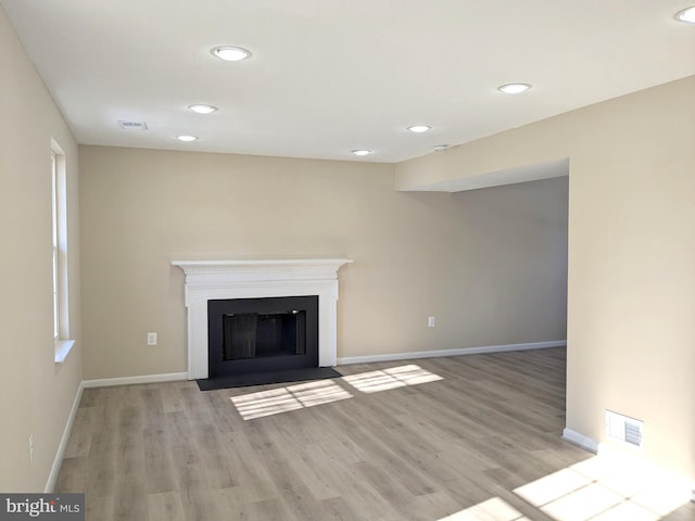 unfurnished living room with light hardwood / wood-style flooring