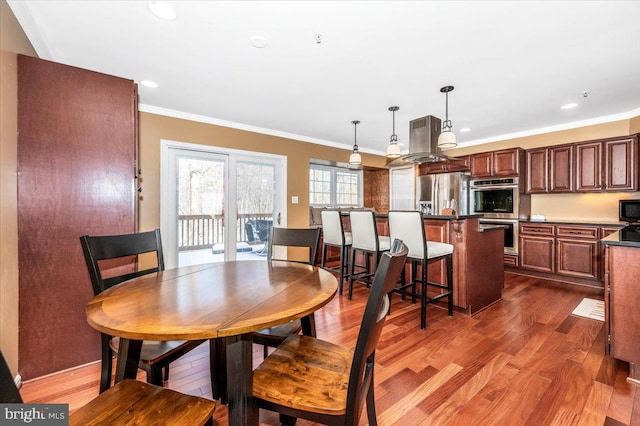 dining room featuring ornamental molding and dark hardwood / wood-style floors