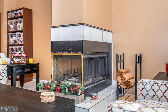 living room featuring a tile fireplace