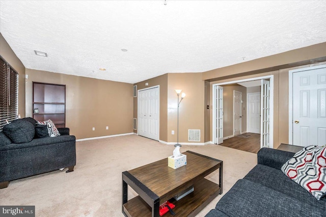 carpeted living room with a textured ceiling